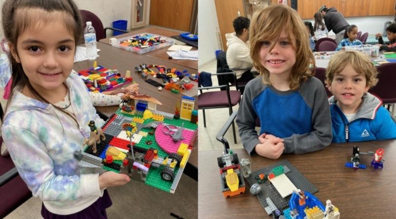 A young girl shows off her LEGO creation.