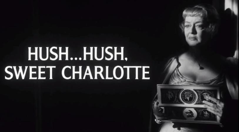 Black-and-white title card reading “HUSH…HUSH, SWEET CHARLOTTE” beside a woman holding a vintage suitcase, lit against a dark background.